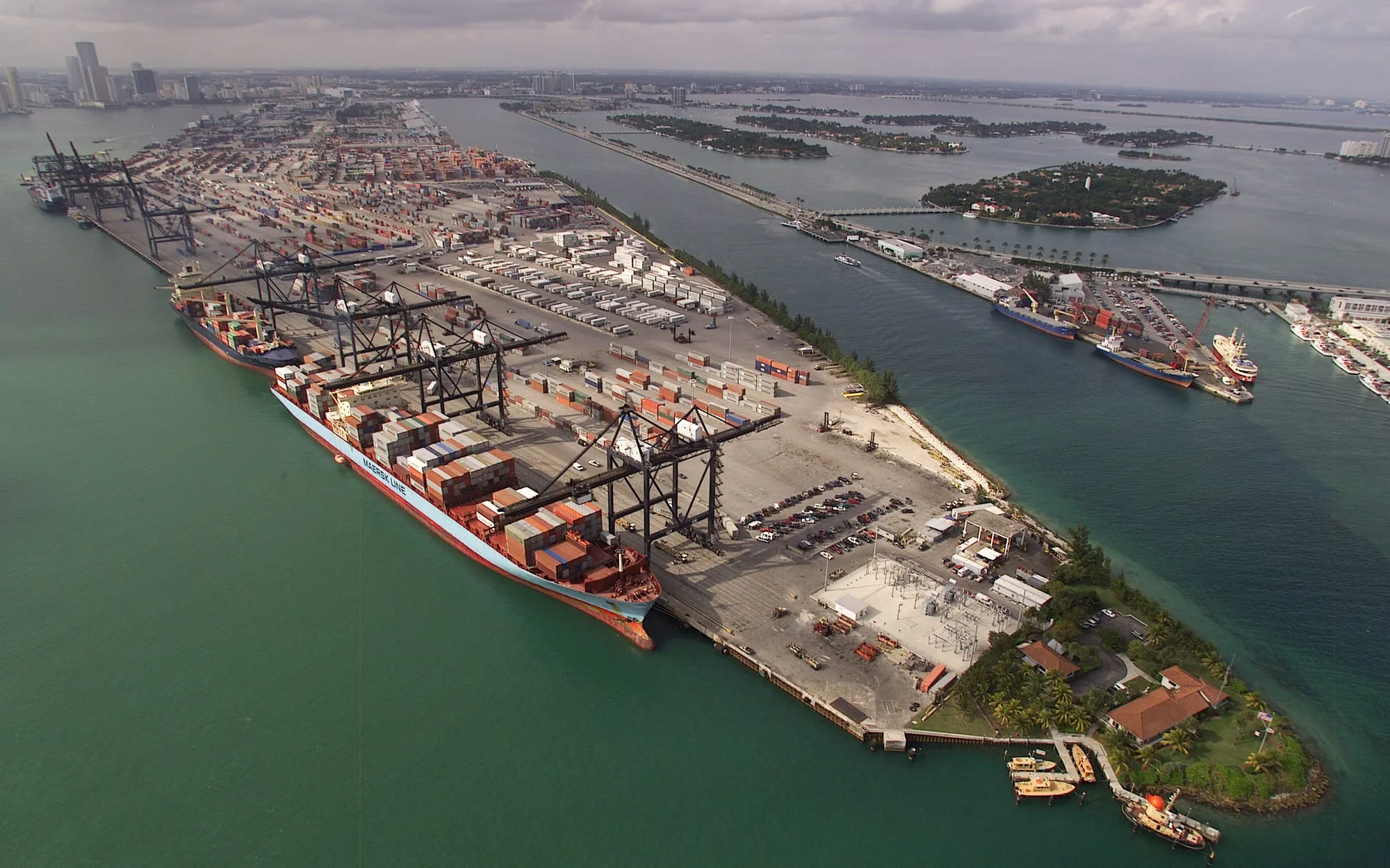 Aerial view of a container port with ships, cranes and stacked containers
