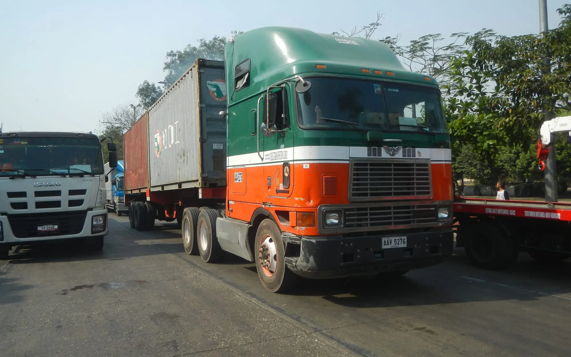 Container truck and trailer on a road in a port area